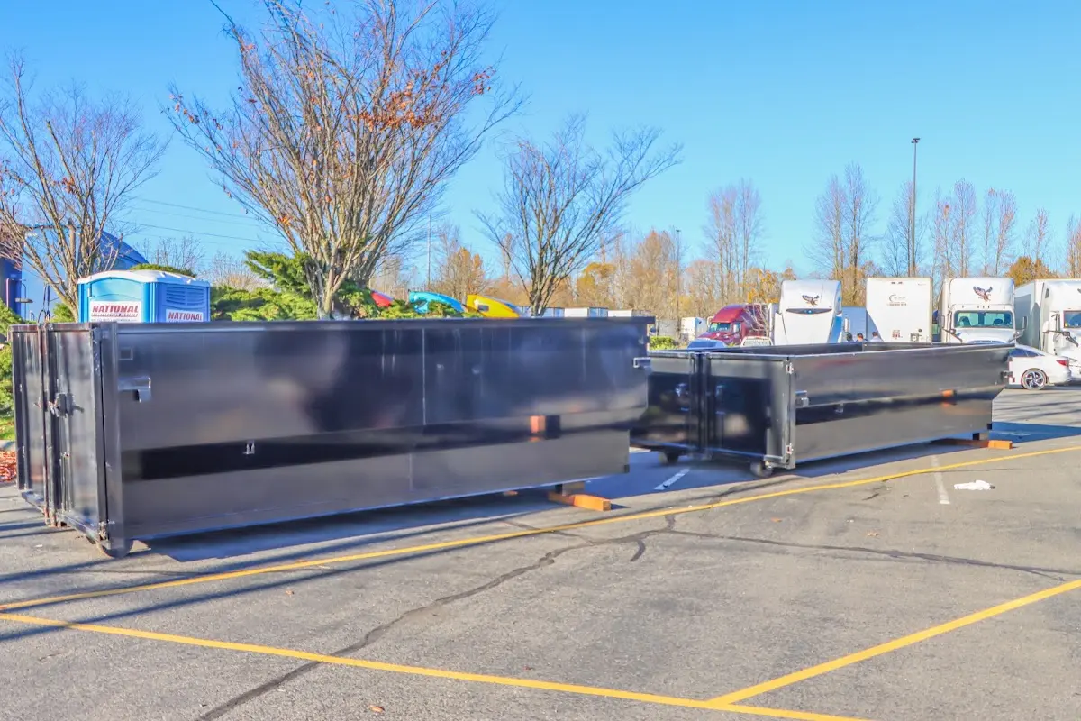 Professional dumpster rental service with roll-off container on residential driveway in San Pablo